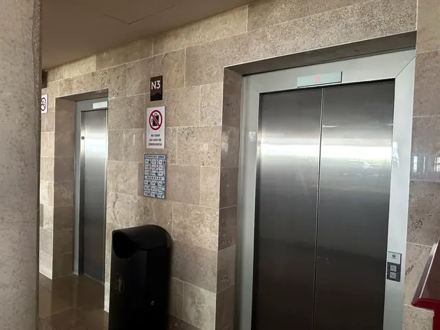 Lobby de elevadores con muros de piedra