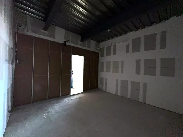 Muro de acceso con puerta hacia el pasillo del edificio